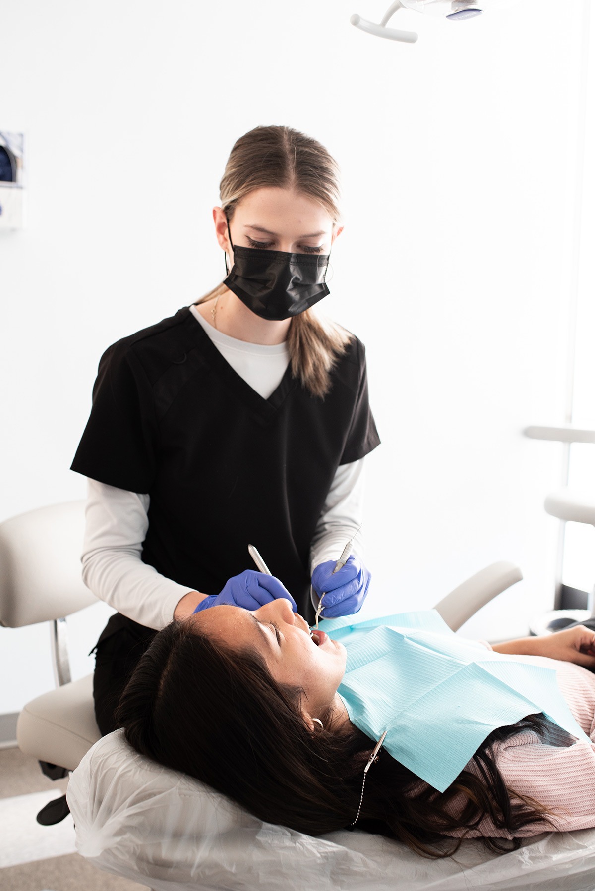 Carolina Roots Dental hygienist caring for a patient in the exam chair