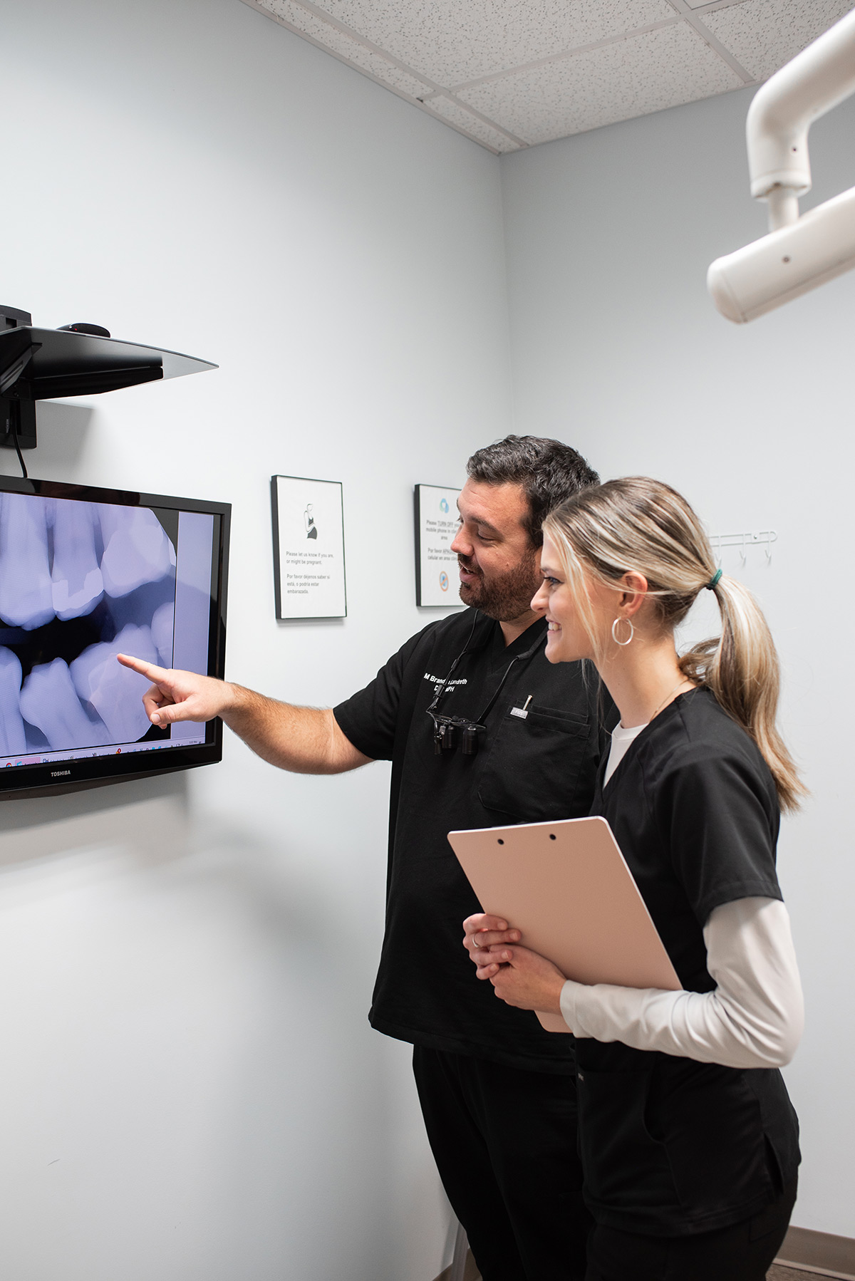 Carolina Roots Dental team reviewing dental X-rays on a monitor