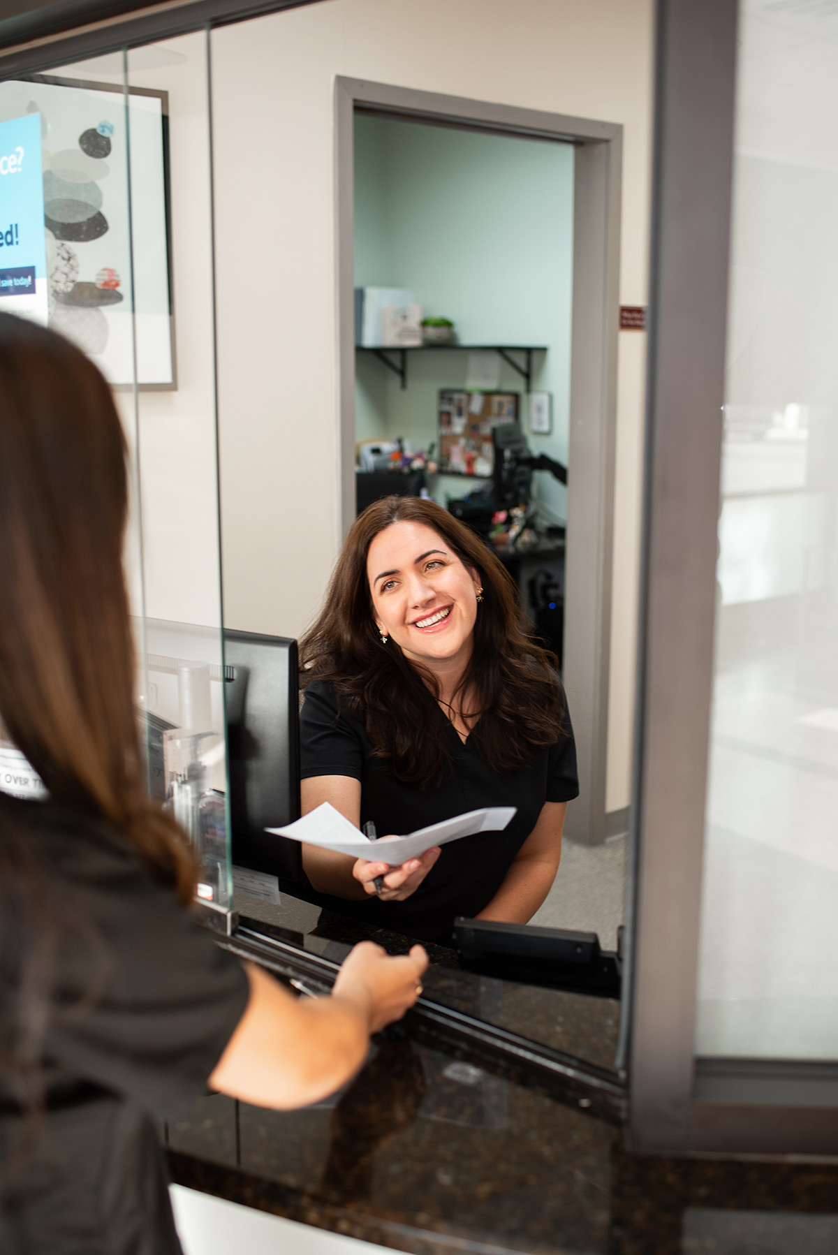 Carolina Roots Dental clinician greeting a patient at reception
