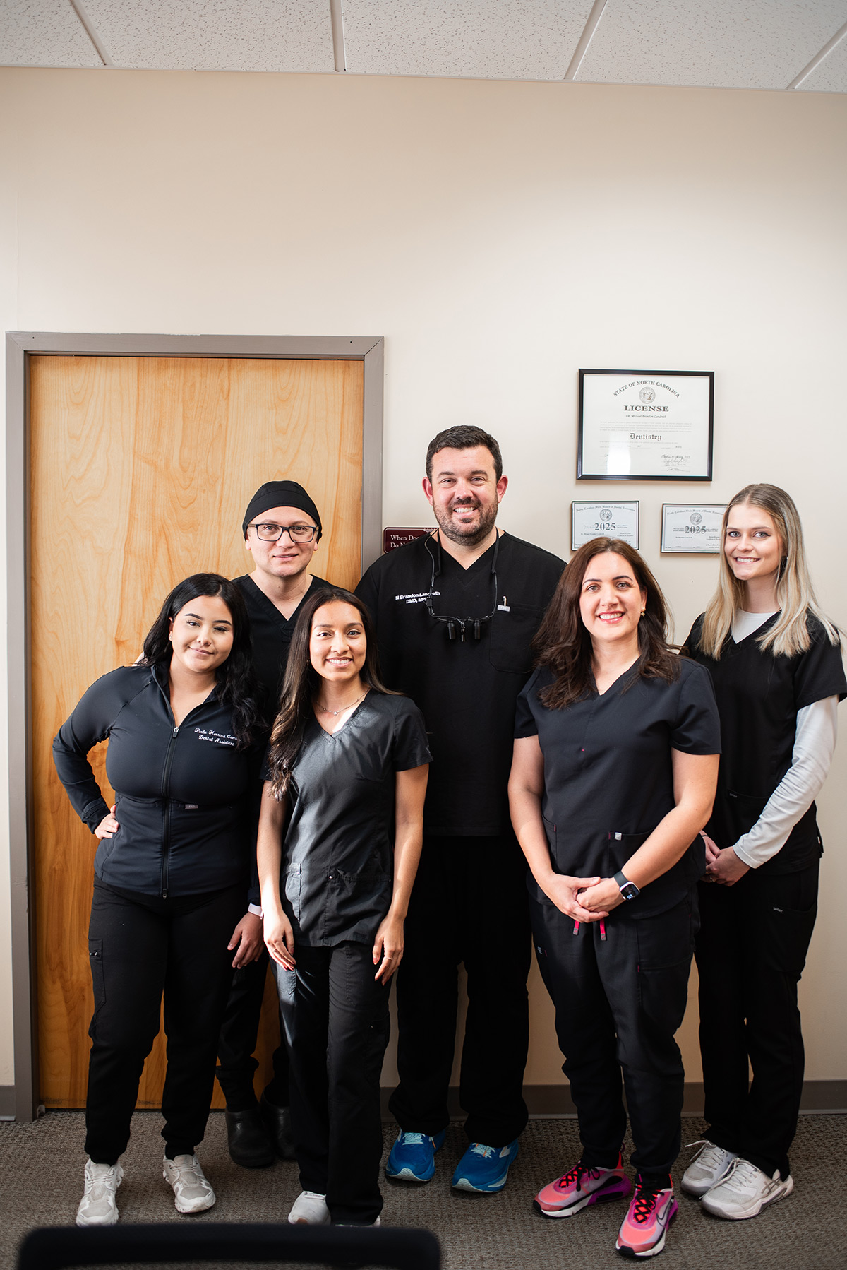 Carolina Roots Dental team standing together in the office