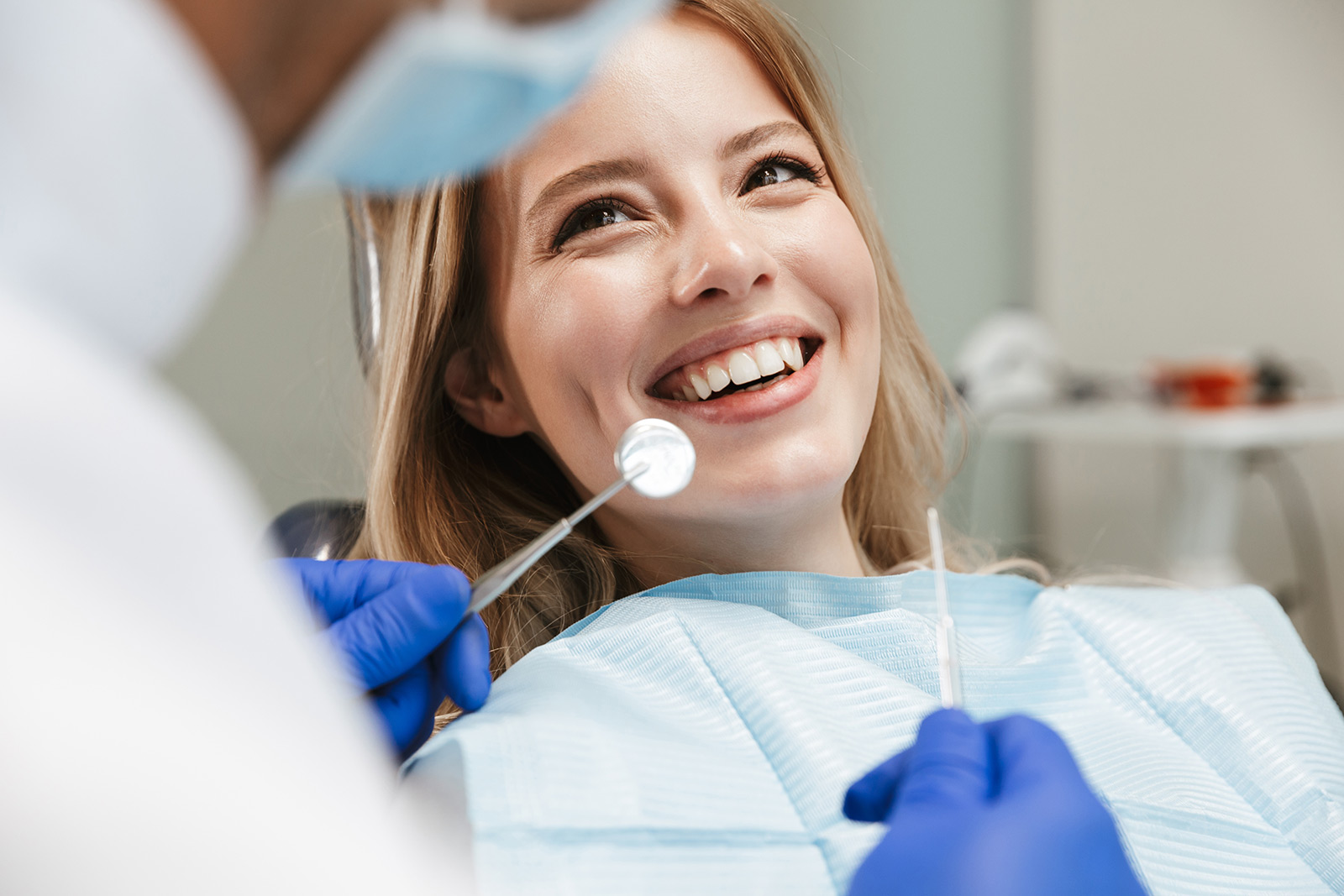 Smiling patient receiving dental care in a treatment chair
